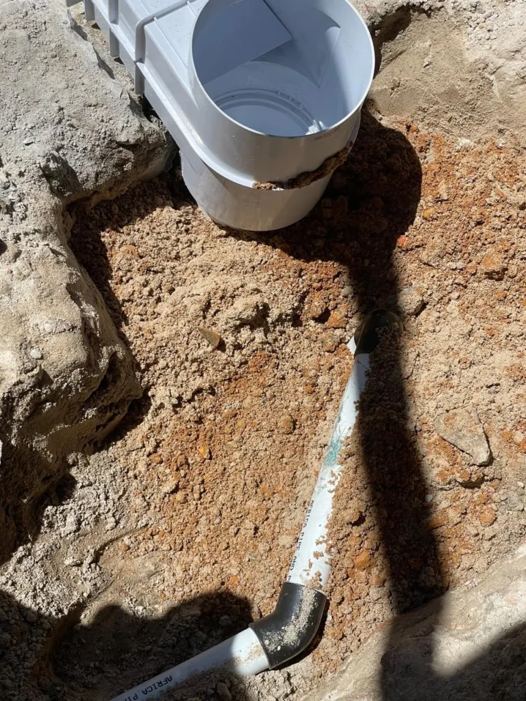 New skimmer box with its suction pipe running through the excavated trench