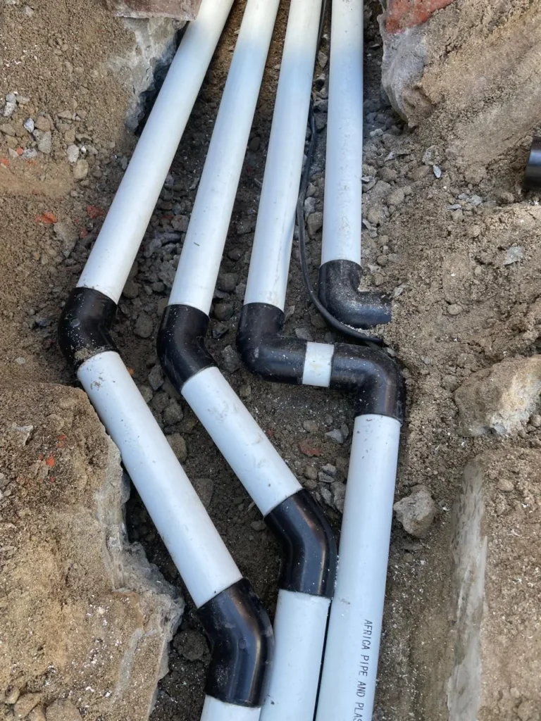 Suction, return and backwash pipes with bends laid side by side in a trench